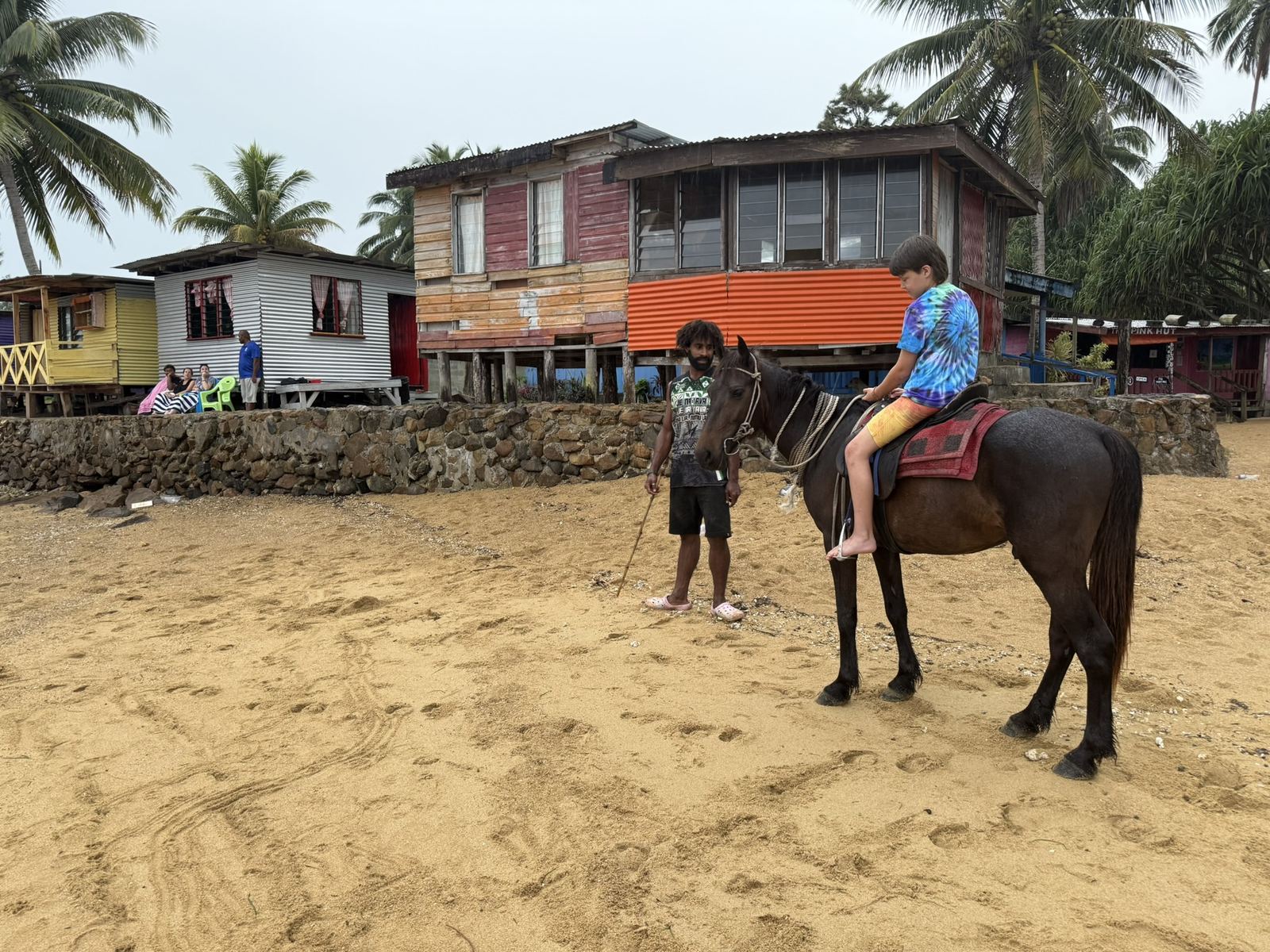 Kid on a horse in the village with local guide